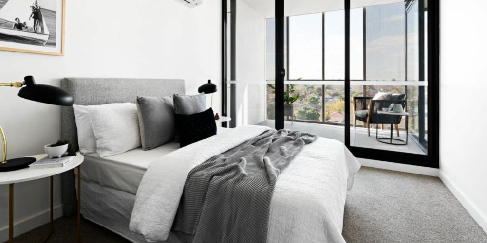 alke apartments bedroom in white and grey hues