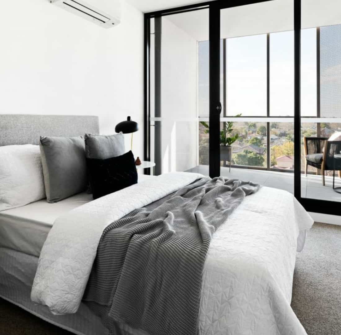 alke apartments bedroom in white and grey hues