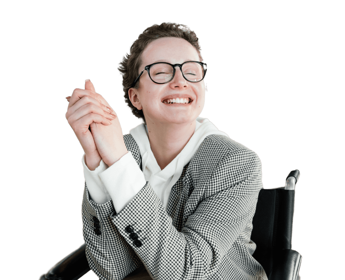 woman in wheelchair smiling at camera with a cheesy grin